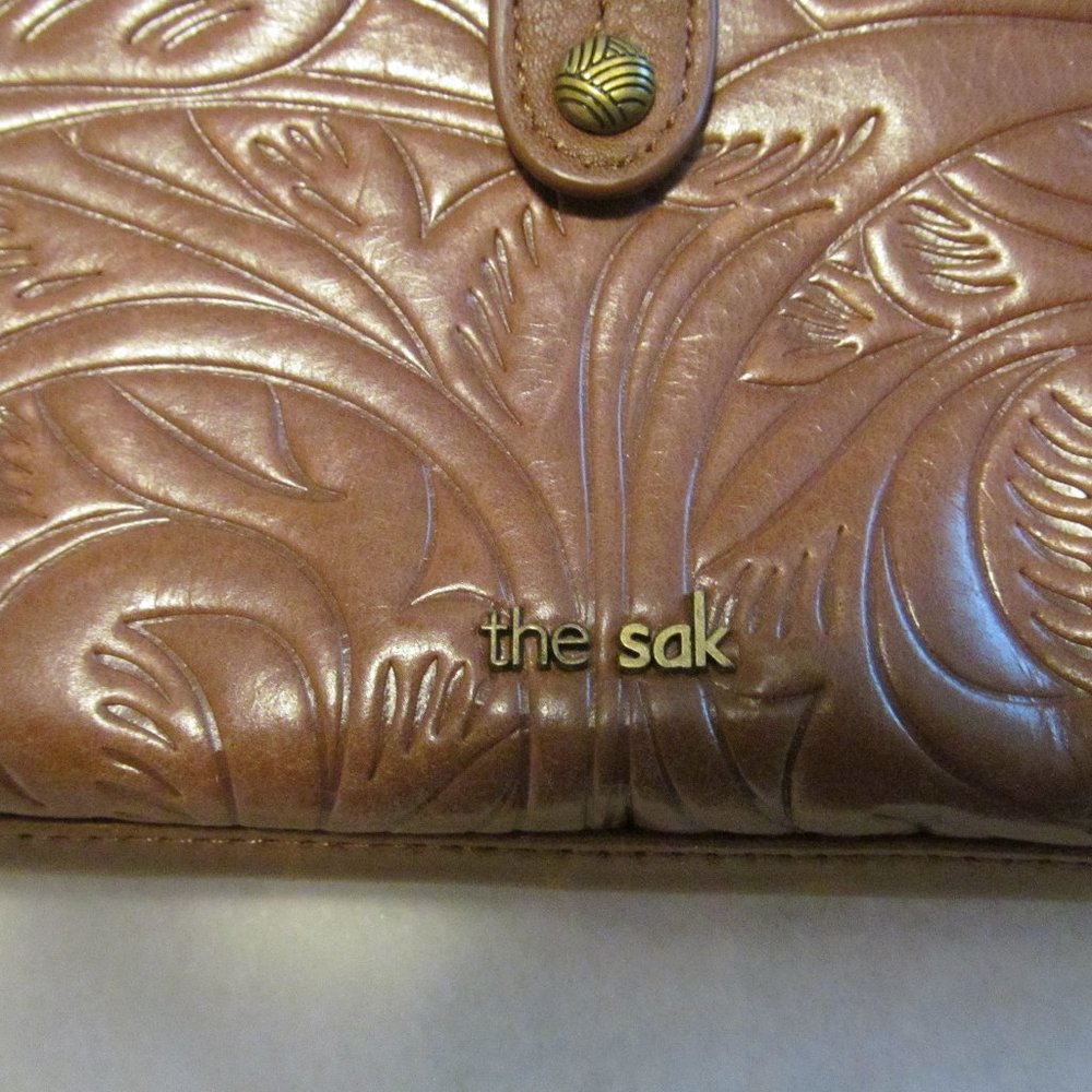 The Sak brown leather style clutch purse.